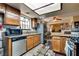Spacious kitchen featuring wood cabinets, granite countertops, stainless steel appliances, and open layout at 3877 Platis Cir, Las Vegas, NV 89103