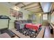 Cozy sunroom featuring a comfortable couch, tiled floors, and natural light streaming through the windows at 3877 Platis Cir, Las Vegas, NV 89103