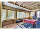 Bright sunroom with large windows, beamed ceiling, tiled floors, and comfortable seating area at 3877 Platis Cir, Las Vegas, NV 89103