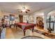 An open floor plan shows a living room with a pool table, and decorative archways leading to other rooms at 3877 Platis Cir, Las Vegas, NV 89103