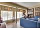 Cozy living space with comfortable seating, window views, and an adjacent area for a work desk at 3877 Platis Cir, Las Vegas, NV 89103