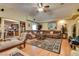 Spacious living room with hardwood floors, vaulted ceilings, large sectional, and elegant furniture at 3877 Platis Cir, Las Vegas, NV 89103