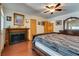 The main bedroom features hardwood floors, a ceiling fan, and a decorative fireplace mantel at 3877 Platis Cir, Las Vegas, NV 89103