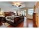 A main bedroom features hardwood floors, a ceiling fan, and windows with translucent shades at 3877 Platis Cir, Las Vegas, NV 89103