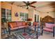 Covered patio with ceiling fan, comfortable seating, and access to the backyard at 3877 Platis Cir, Las Vegas, NV 89103
