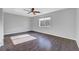 Spacious bedroom with hardwood floors, a ceiling fan, and large window at 3908 Total Eclipse St, Las Vegas, NV 89129