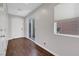 A view of the entryway with wood floors, light gray walls, and a modern door at 3908 Total Eclipse St, Las Vegas, NV 89129