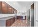 Modern kitchen features stainless steel appliances, granite countertops, and dark wood cabinets at 3908 Total Eclipse St, Las Vegas, NV 89129