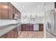 Modern kitchen features stainless steel appliances, granite countertops, and dark wood cabinets at 3908 Total Eclipse St, Las Vegas, NV 89129
