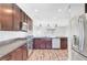 Modern kitchen features stainless steel appliances, granite countertops, and dark wood cabinets at 3908 Total Eclipse St, Las Vegas, NV 89129