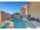 Gorgeous backyard pool with a waterfall feature and lush landscaping, perfect for relaxing and entertaining guests at 3908 Total Eclipse St, Las Vegas, NV 89129