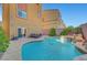 Backyard pool area with comfortable chaise lounges and lush landscaping at 3908 Total Eclipse St, Las Vegas, NV 89129