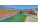 Outdoor roof top living area with a built-in fireplace and bar, with artificial grass and comfortable seating at 3908 Total Eclipse St, Las Vegas, NV 89129
