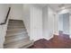 Carpeted stairs lead to the upper level of this home with hardwood flooring at 3908 Total Eclipse St, Las Vegas, NV 89129