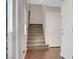 Carpeted stairway leading to the upper level, complemented by wood floors and natural light at 3908 Total Eclipse St, Las Vegas, NV 89129