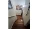 Wooden staircase descends into a home, enhanced by charming wall decor and a welcoming ambiance at 3975 N Hualapai Way # 246, Las Vegas, NV 89129