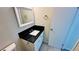 Bathroom showcasing a vanity with a black countertop, mirror, and fixtures at 4238 Boratko St, Las Vegas, NV 89115