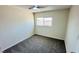 Cozy bedroom with neutral walls, carpet, ceiling fan and a window providing natural light at 4238 Boratko St, Las Vegas, NV 89115