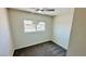 Cozy bedroom with neutral carpet, ceiling fan, and natural light at 4238 Boratko St, Las Vegas, NV 89115