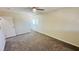 Spacious bedroom featuring gray carpet, neutral paint, a door and a bright window at 4238 Boratko St, Las Vegas, NV 89115