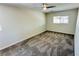 Spacious bedroom showcasing gray carpeting, neutral walls, and a bright window at 4238 Boratko St, Las Vegas, NV 89115