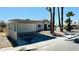 View of single-story home with covered parking, desert landscaping, and palm trees at 4238 Boratko St, Las Vegas, NV 89115