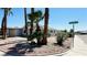 Street view of home with covered parking, desert landscaping, and palm trees at 4238 Boratko St, Las Vegas, NV 89115