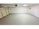 Spacious garage with epoxy flooring, overhead lighting, and an automatic garage door at 4238 Boratko St, Las Vegas, NV 89115