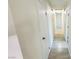 Hallway with white walls, tile flooring, and multiple doors at 4238 Boratko St, Las Vegas, NV 89115