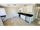 Bright, renovated kitchen has tile flooring, white cabinets and stainless steel appliances at 4238 Boratko St, Las Vegas, NV 89115