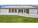 Well-maintained backyard featuring lush lawn, mature landscaping, and rear home view at 5000 Linkside Dr, Las Vegas, NV 89130