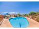 Community pool area with sun loungers, shaded seating, and a clear blue pool at 5000 Linkside Dr, Las Vegas, NV 89130