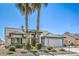 Charming single-story home with a well-manicured front yard and mature palm trees at 5000 Linkside Dr, Las Vegas, NV 89130