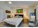 Bedroom featuring a queen size bed, side tables with lamps, a chair and wall decorations at 5415 W Harmon Ave # 2075, Las Vegas, NV 89103