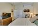 Bedroom featuring a queen size bed, a television on a wicker stand and closet access at 5415 W Harmon Ave # 2075, Las Vegas, NV 89103