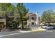 Inviting condo exterior features neutral stucco, covered parking, and mature landscaping at 5415 W Harmon Ave # 2075, Las Vegas, NV 89103