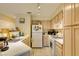 A kitchen has white appliances, light wood cabinets, and white countertops at 5415 W Harmon Ave # 2075, Las Vegas, NV 89103