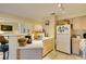 This kitchen features an eat-in counter and white appliances at 5415 W Harmon Ave # 2075, Las Vegas, NV 89103