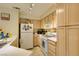 A kitchen has white appliances and light wood cabinets at 5415 W Harmon Ave # 2075, Las Vegas, NV 89103