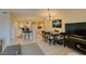 Combined living and dining area with tile flooring, a TV entertainment center and access to the kitchen at 5415 W Harmon Ave # 2075, Las Vegas, NV 89103