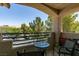 Patio featuring chairs and a table with a view of the street, trees and cars at 5415 W Harmon Ave # 2075, Las Vegas, NV 89103