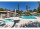 Community pool and spa with lounge chairs surrounded by mature trees and landscaping at 5415 W Harmon Ave # 2075, Las Vegas, NV 89103