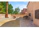 A spacious backyard featuring a brick patio, gravel landscape, and a view of the property's exterior at 5917 Horsehair Blanket Dr, North Las Vegas, NV 89081