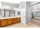Bathroom featuring wood cabinetry, a large mirror, and access to the Primary bedroom at 5917 Horsehair Blanket Dr, North Las Vegas, NV 89081