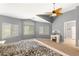 Bright bedroom showcasing large windows, a ceiling fan, and neutral paint, creating a serene atmosphere at 5917 Horsehair Blanket Dr, North Las Vegas, NV 89081