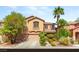 Charming two-story home featuring desert landscaping, mature palm trees, and a two-car garage at 5917 Horsehair Blanket Dr, North Las Vegas, NV 89081