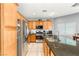 Well lit kitchen with wood cabinets, stainless steel appliances and tile floors at 5917 Horsehair Blanket Dr, North Las Vegas, NV 89081