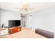 Spacious living room with a ceiling fan, a large TV, and modern furnishings at 5917 Horsehair Blanket Dr, North Las Vegas, NV 89081