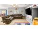 Cozy living room with plush seating, ceiling fan, and a decorative entertainment center at 5917 Horsehair Blanket Dr, North Las Vegas, NV 89081