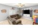 Inviting living room with tiled floors, ceiling fan, and a built-in media nook at 5917 Horsehair Blanket Dr, North Las Vegas, NV 89081